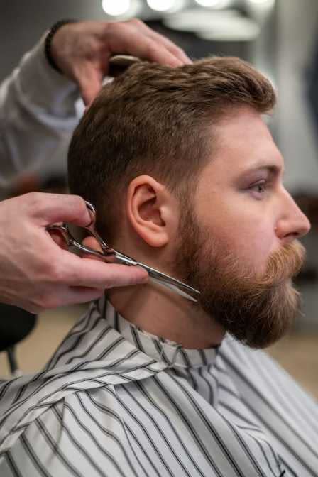 barber trimming clients beard split-ends