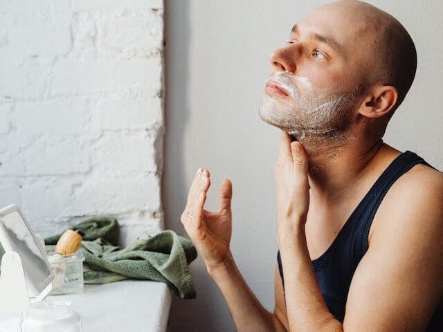 a man exfoliating his face